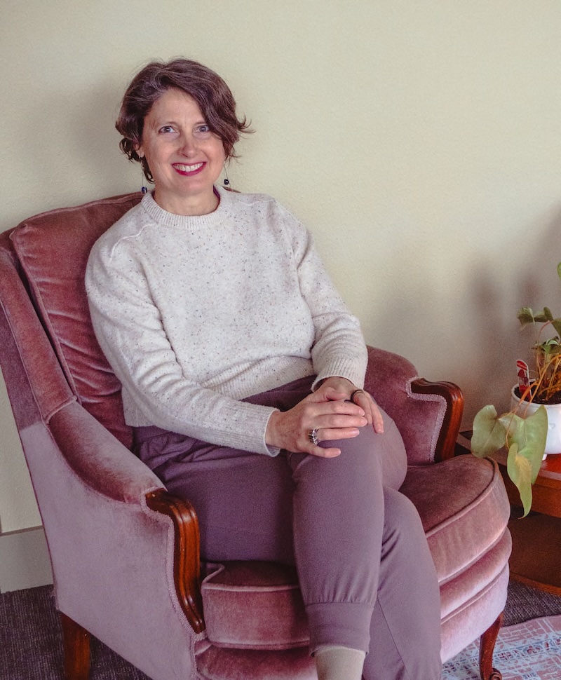 smiling in the chair at Glimmer Wellness