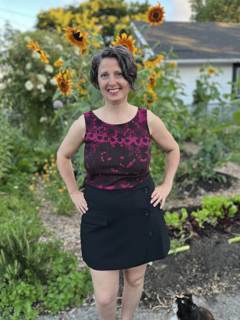 Standing in the garden with sunflowers and cat